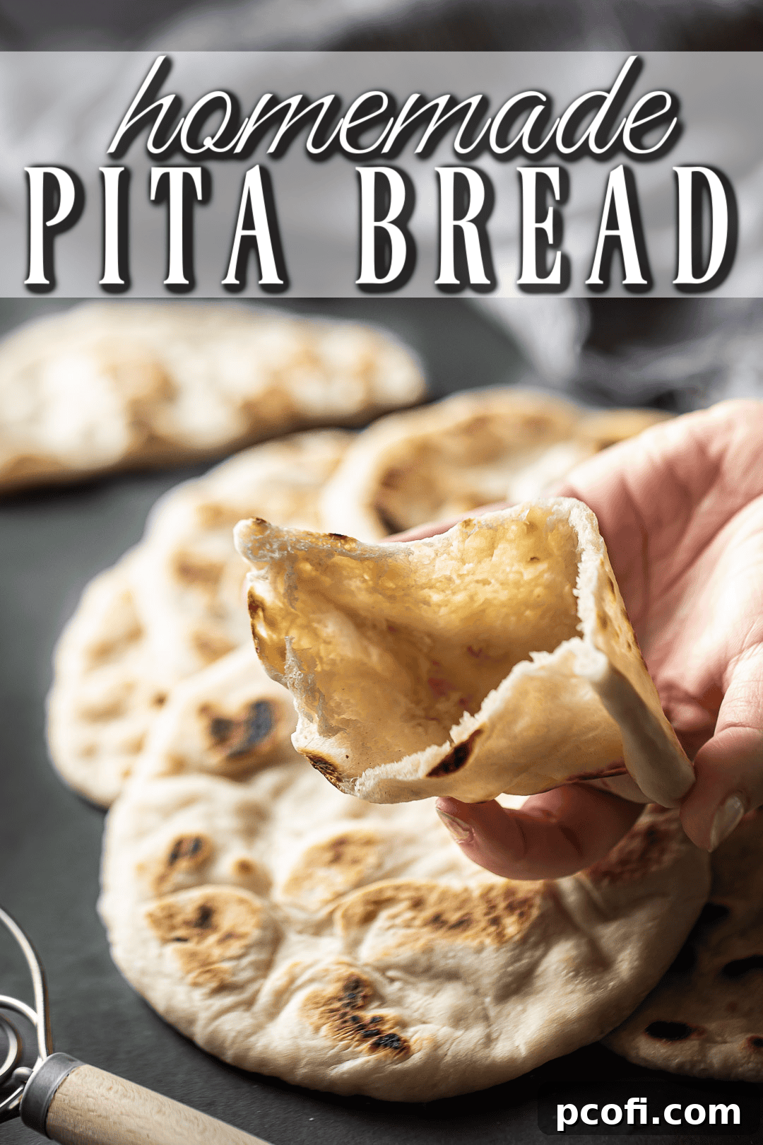 A freshly cooked pita bread, cut in half to reveal its iconic inner pocket, perfect for stuffing with fillings.