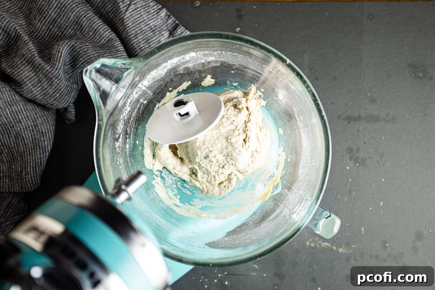 Rough, shaggy pita bread dough before the kneading process, showcasing its initial texture.