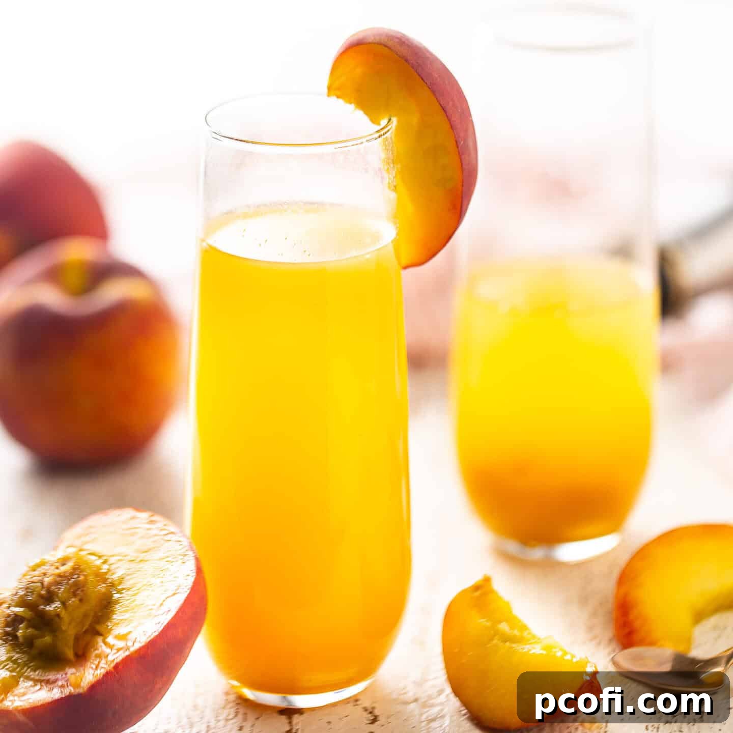 A refreshing Peach Bellini cocktail served in an elegant champagne flute, garnished with a fresh peach wedge, set against a bright, inviting background.
