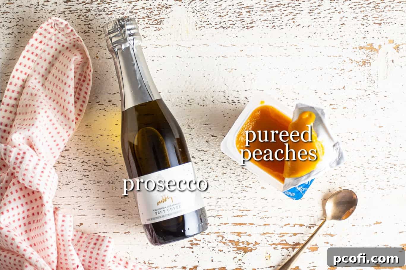 Essential ingredients for making a Peach Bellini, including a jar of peach puree and a bottle of sparkling wine, clearly labeled for easy identification.