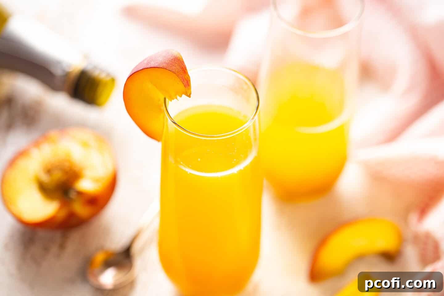 A top-down view of a Peach Bellini recipe being prepared, highlighting the ease of the process with an easy hack.