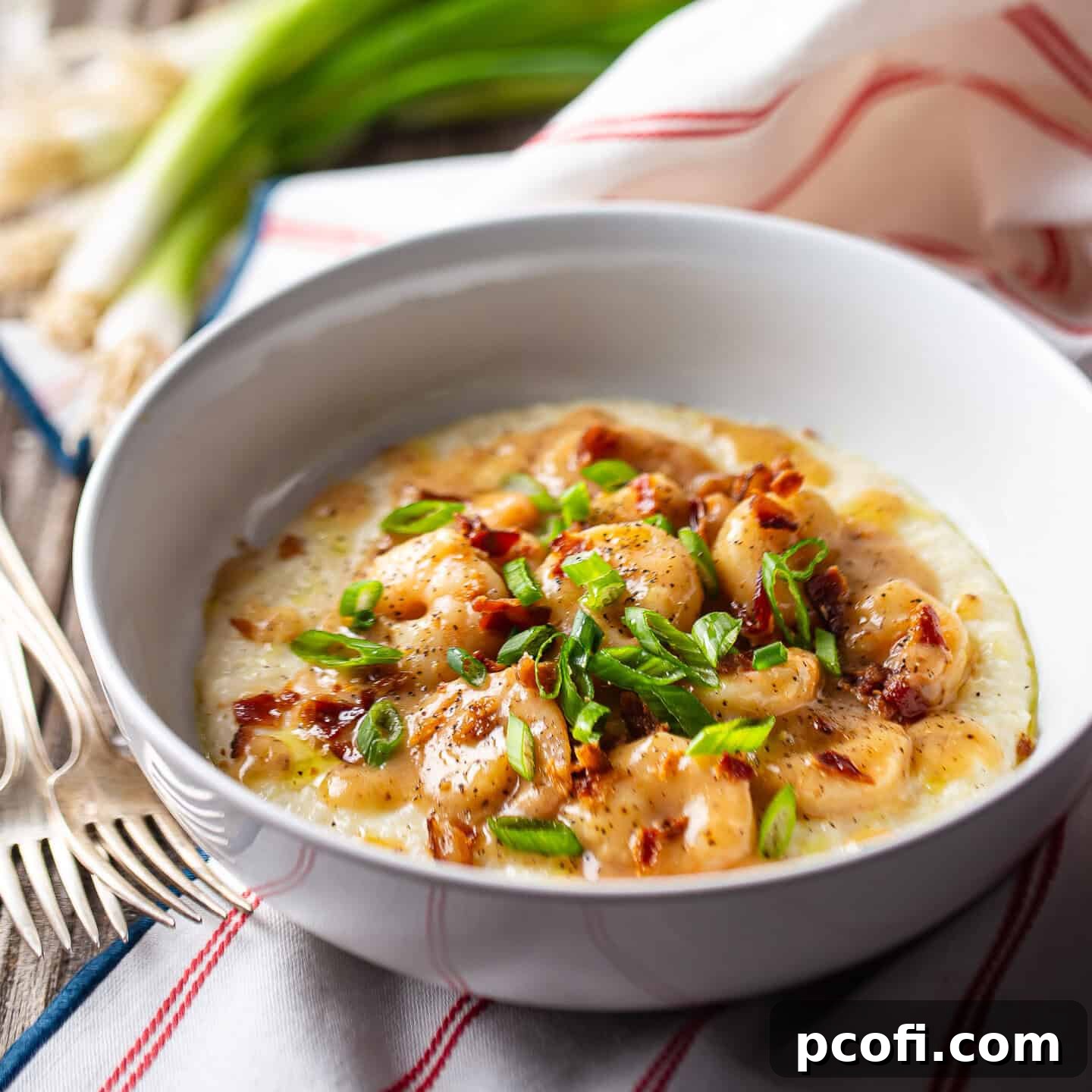 Shrimp and grits in a wide ceramic bowl.