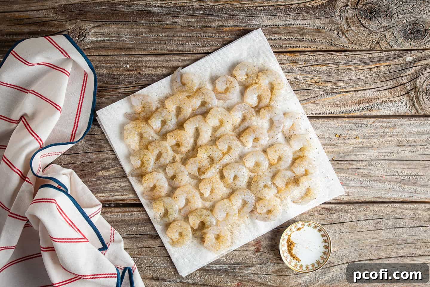 Seasoning peeled and deveined shrimp with cajun seasoning or Old Bay.