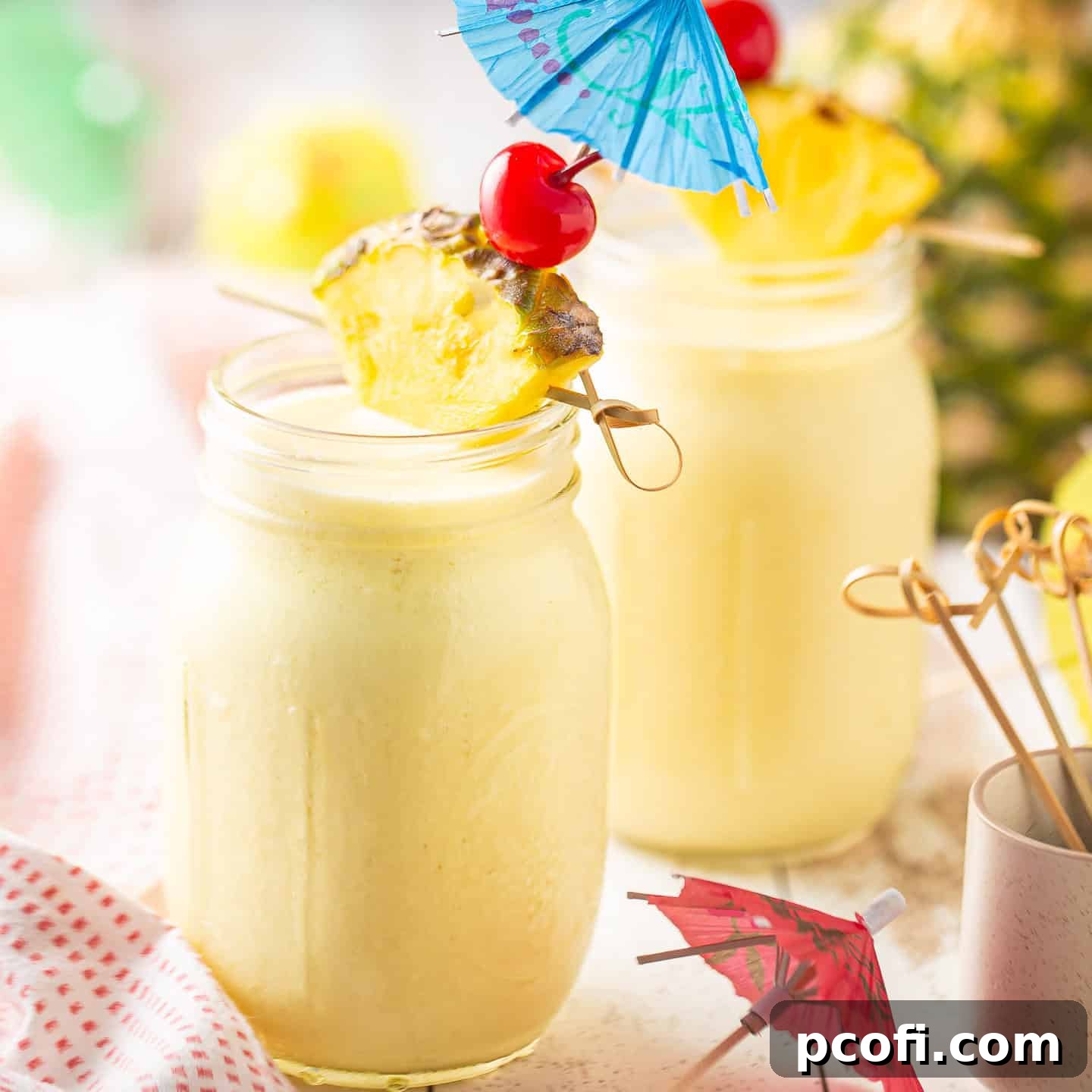 Pina colada served in a mason jar with an umbrella.