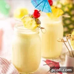 Pina colada served in a mason jar with an umbrella.