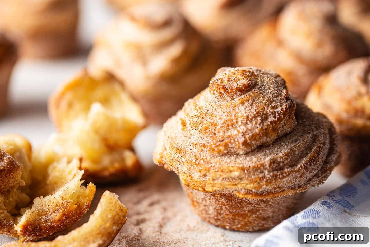 A complete recipe for cruffins, beautifully prepared and presented on a white background with a charming periwinkle blue cloth.