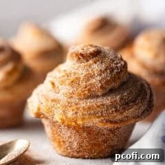 A cruffin pastry with cinnamon sugar coating.