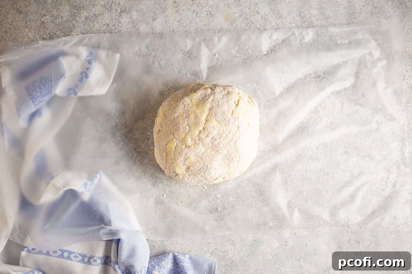 The stiff dough gathered into a ball, wrapped in plastic wrap and ready for chilling.