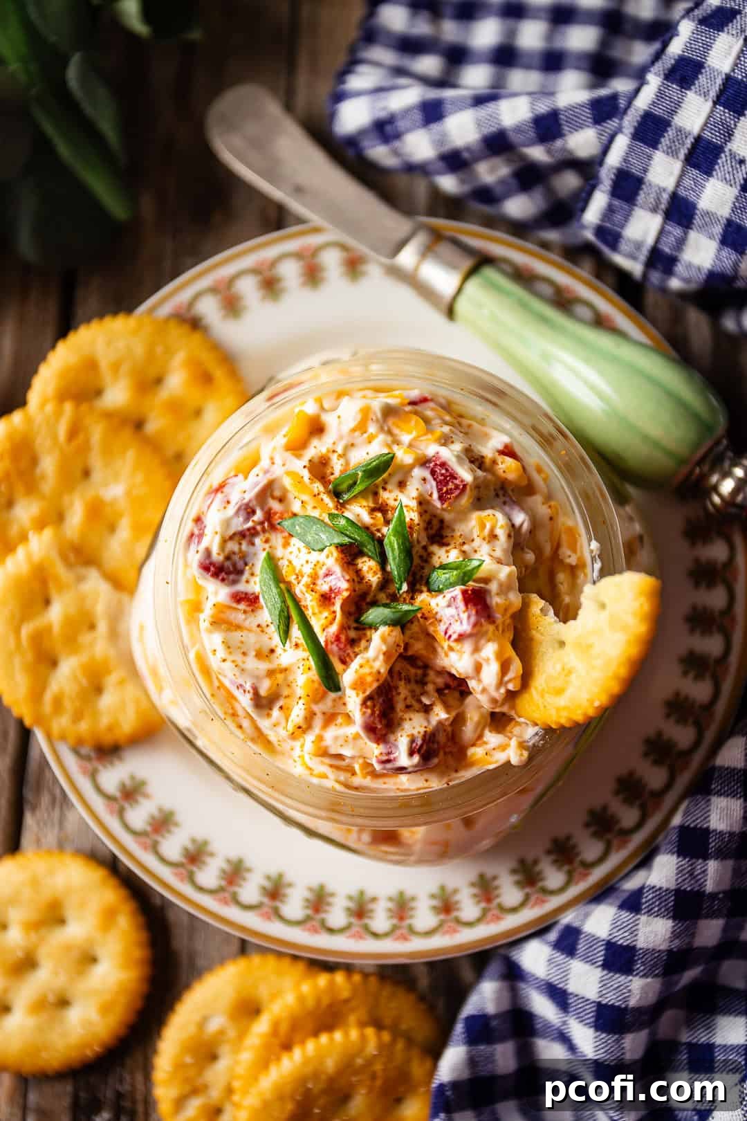 Homemade pimento cheese garnished with cayenne and scallions.