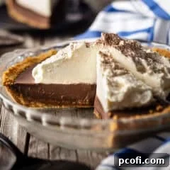 Chocolate pudding pie with a slice removed to highlight the creamy interior.