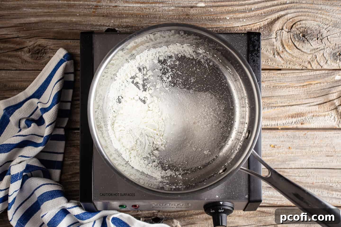 Granulated sugar, cornstarch, and salt are perfectly combined in a small pot, preparing the dry base for the chocolate pudding.