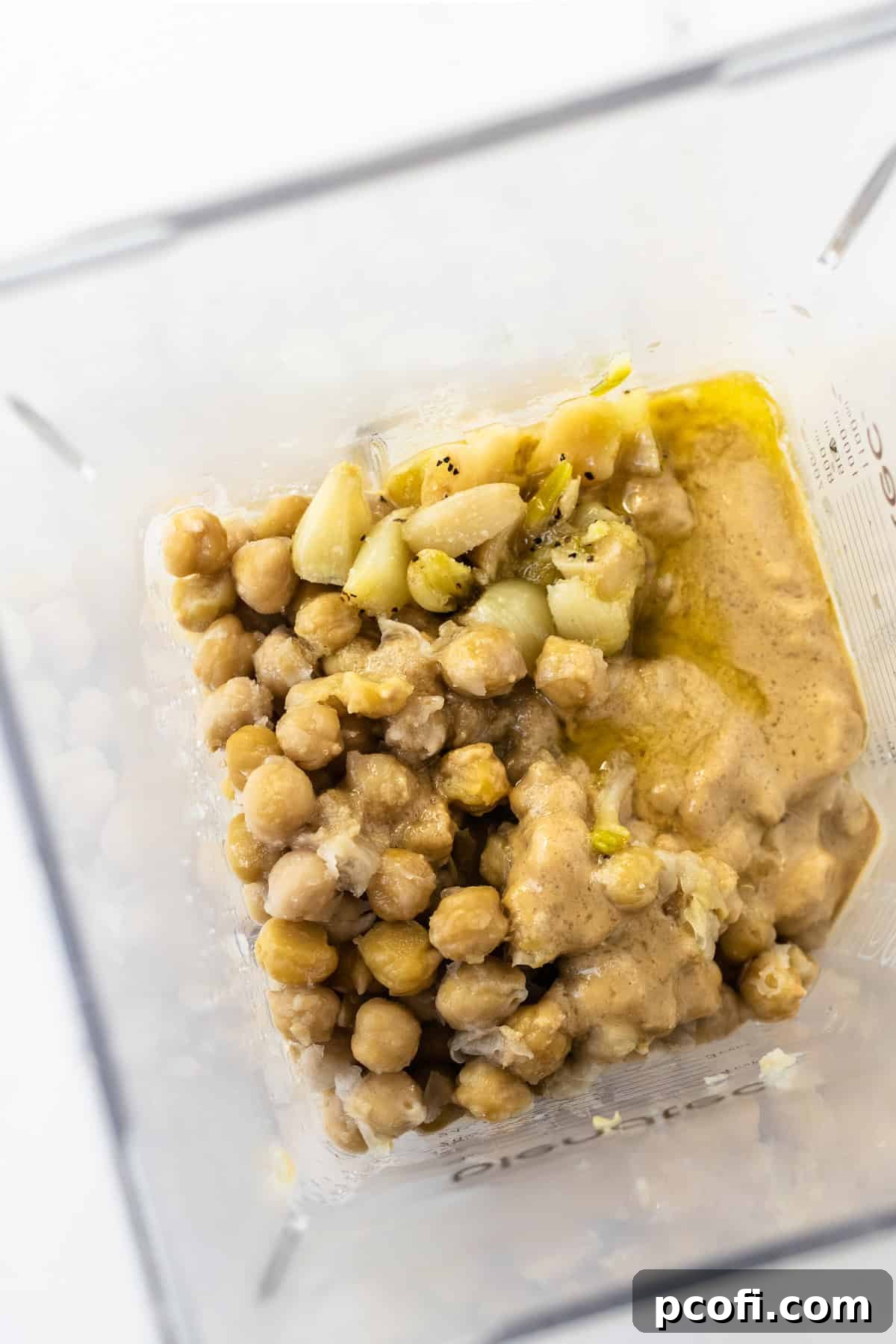 Hummus ingredients: chickpeas, tahini, lemon, garlic, olive oil, and baking soda, ready to be blended.