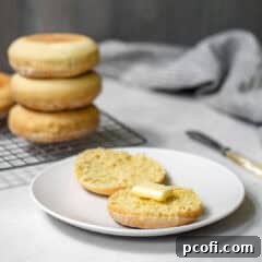 English muffins on a plate with butter.