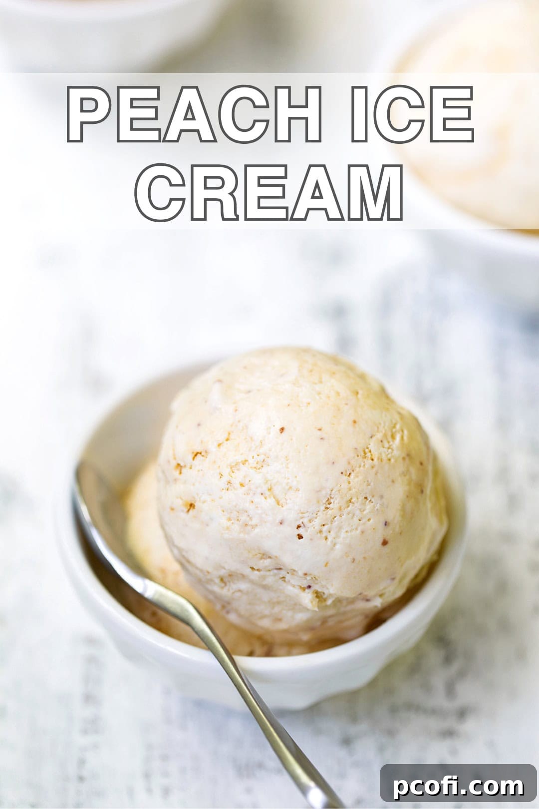 Close-up of creamy peach ice cream with a spoon scooping a portion
