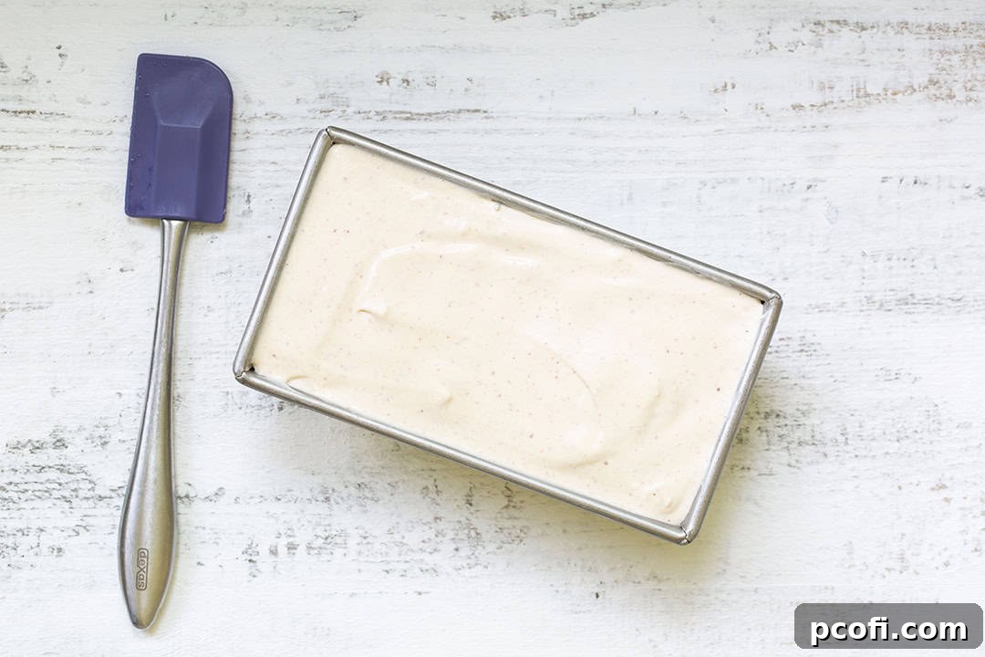 Peach ice cream base in a loaf pan, ready to be frozen
