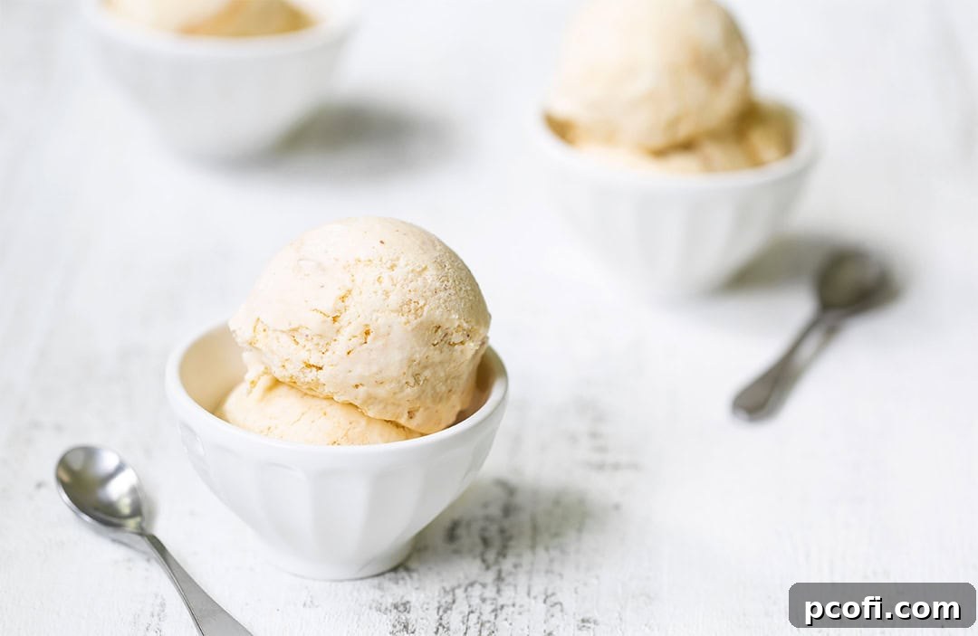 Peach ice cream in 3 bowls with spoons, presented beautifully