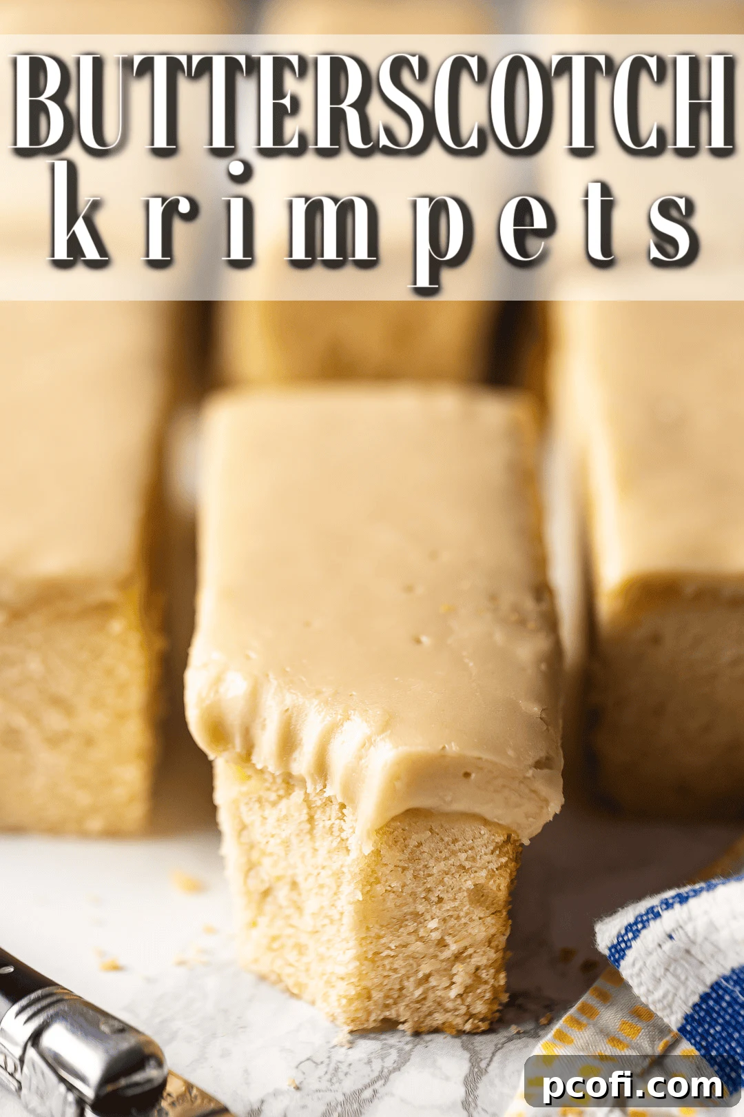 A close-up of a homemade butterscotch krimpet, perfectly cut with a delicious bite taken from one corner, showcasing the soft cake and thick icing.