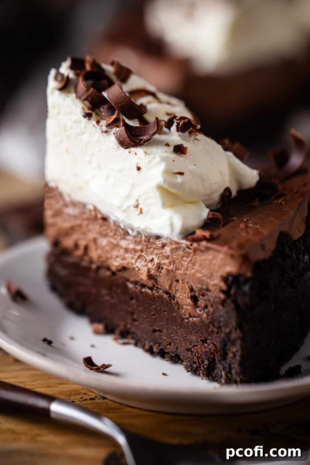 Recipe for Mississippi mud pie, prepared and sliced, and served on a white plate with a vintage bakelite fork.