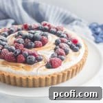 A tantalizing S'mores Berry Tart, combining classic s'mores flavors with fresh berries, topped with toasted meringue.