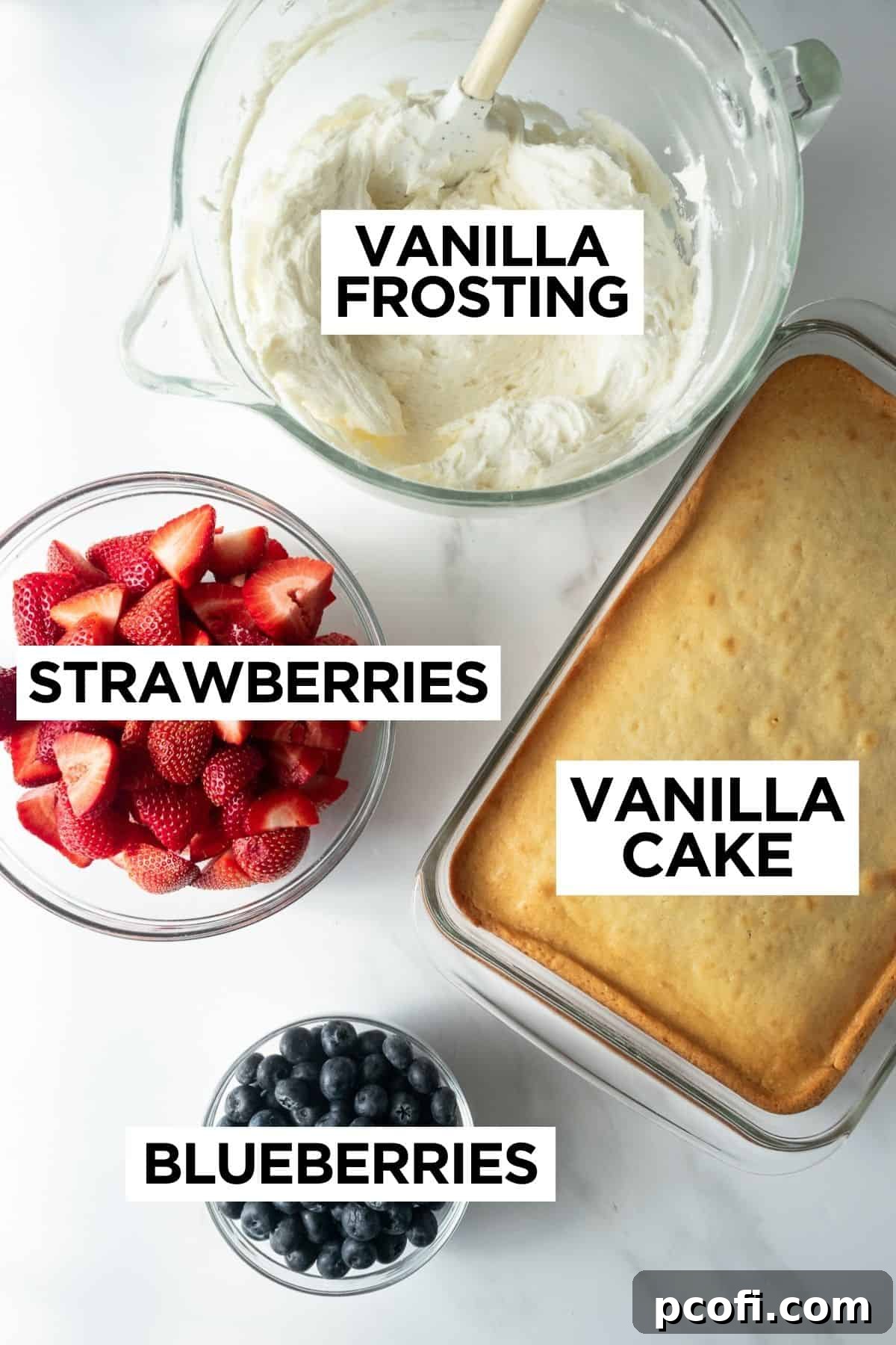 Fresh, vibrant blueberries and halved strawberries, along with other ingredients, prepared for decorating an American flag cake on a white surface.