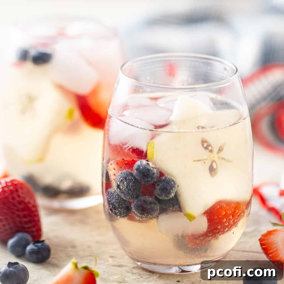 White sangria recipe, prepared and served in stemless wine glasses.