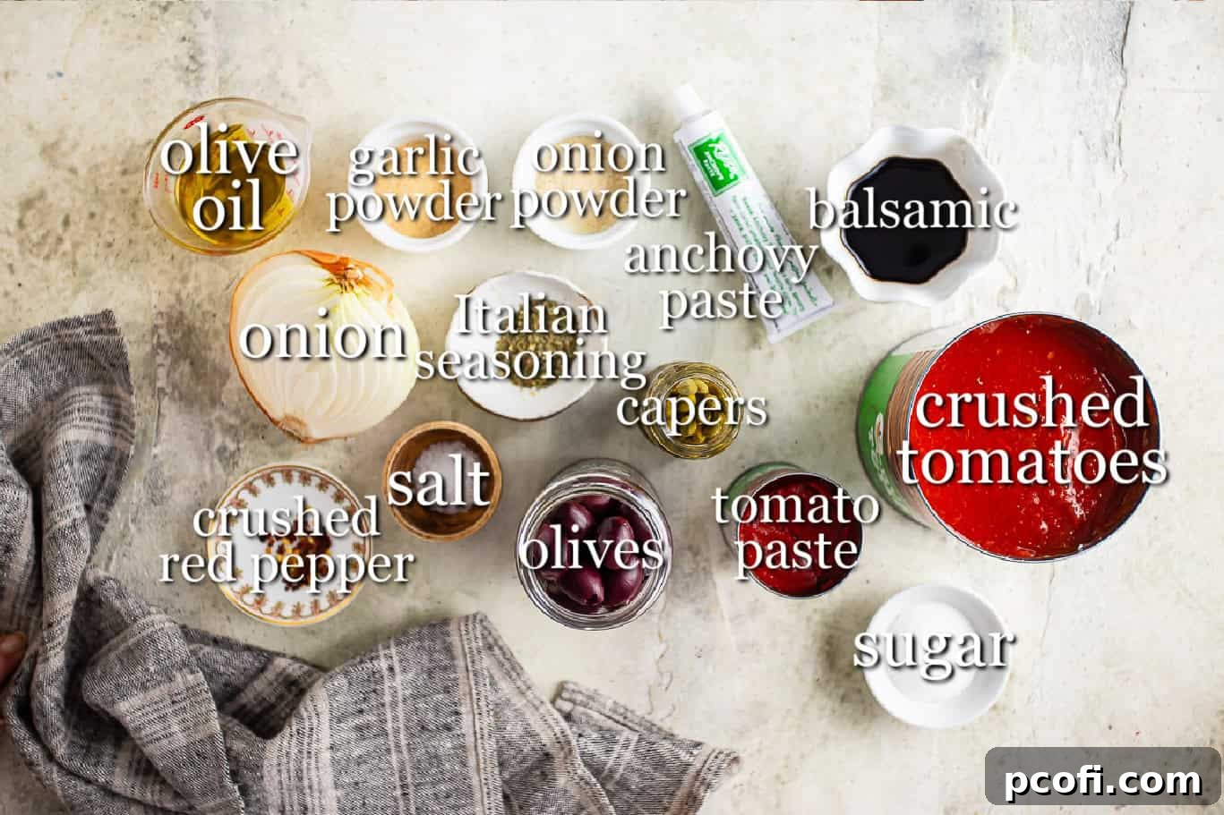 A selection of ingredients for making puttanesca sauce, including olive oil, chopped onion, jars of olives and capers, tomato paste, anchovy paste, and crushed tomatoes, all neatly arranged with text labels.
