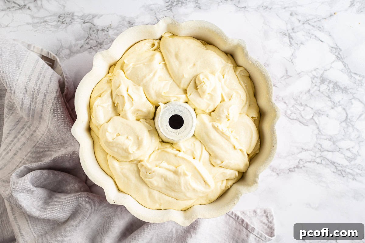 Unbaked cream cheese pound cake in a bundt pan.