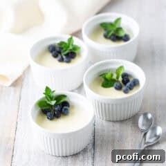 Four individual ramekins of lemon posset, a creamy, zesty, and elegant dessert.