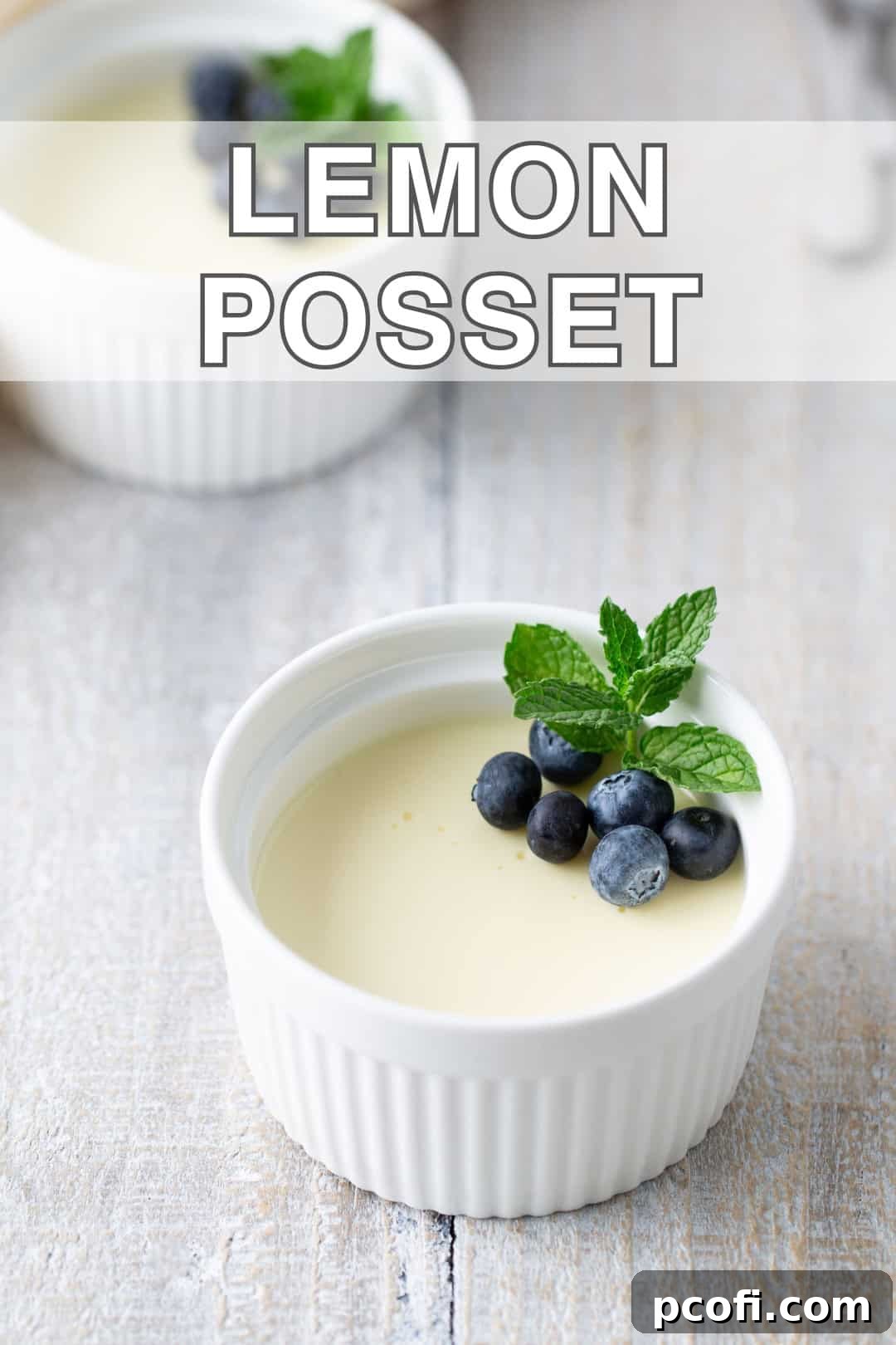 Close-up of a single serving of lemon posset in a glass, highlighting its smooth, lustrous surface.