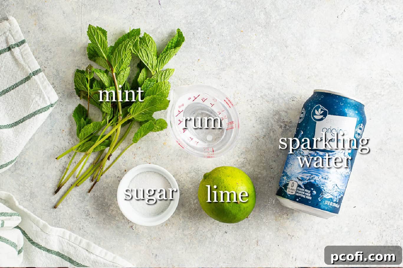 All the fresh ingredients meticulously arranged for making mojitos, including vibrant mint, bright limes, sugar, rum, and sparkling water.
