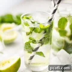 Mojito in a tall, clear glass with lots of fresh mint.