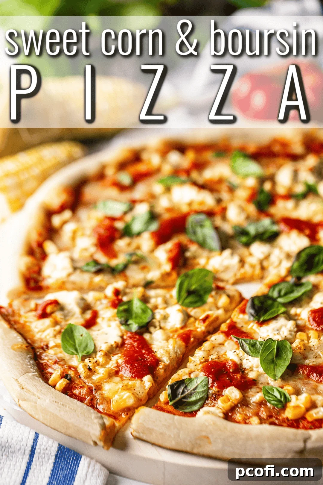 A hand reaching for a slice of freshly baked corn pizza, with a banner above reading "Sweet Corn and Boursin Pizza." The crust is golden, and the cheese is bubbly.