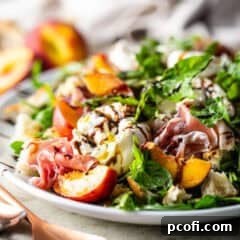 Peach salad presented on a white oval ceramic platter.