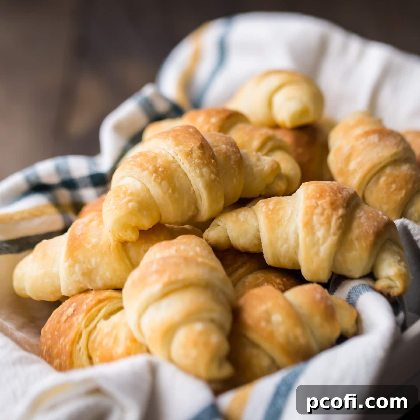 A tray of beautifully golden and flaky homemade crescent rolls, promising a delightful texture with every bite.