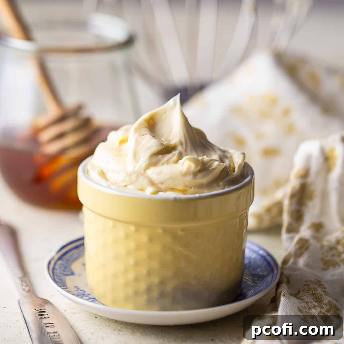 Whipped honey butter in a small hobnail ramekin, ready to be served.