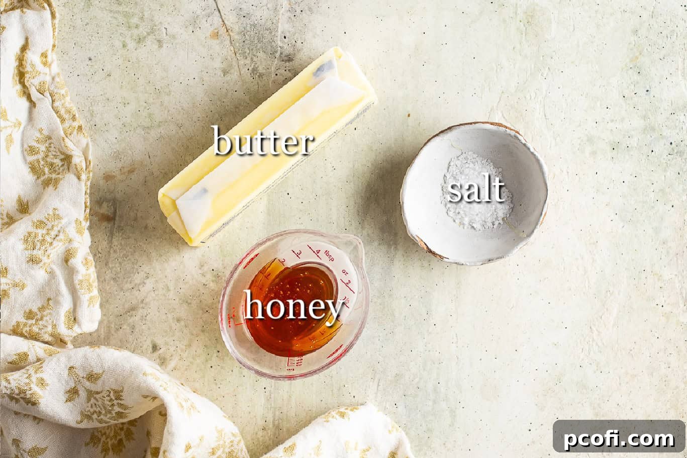 Ingredients for making honey butter, with text labels for butter, salt, and honey.