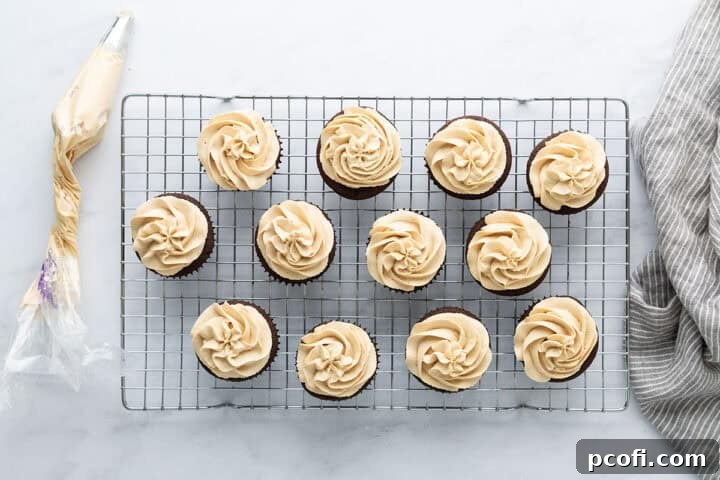 Beautifully frosted chocolate peanut butter cupcakes arranged on a wire rack, ready to be enjoyed