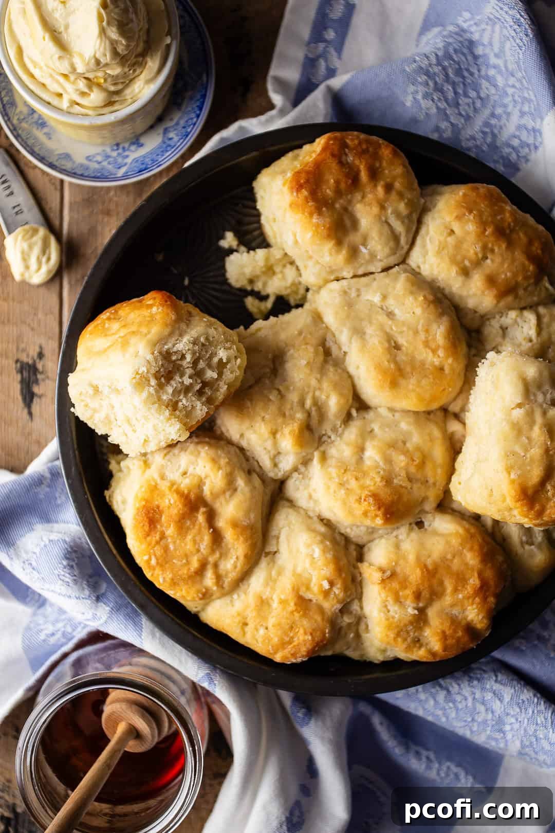 Overhead image of homemade angel biscuits with honey and butter.