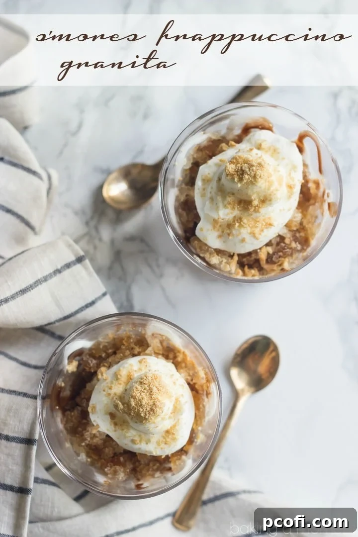 Close-up of a S'mores Frappuccino Granita glass, showing layers of coffee granita, marshmallow, chocolate, whipped cream, and graham cracker crumbs.
