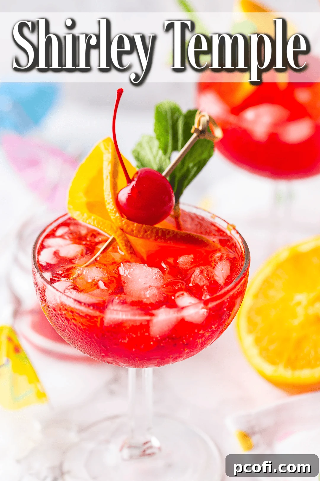 A bright pink Shirley Temple mocktail, perfectly prepared and served in elegant stemmed glassware, ready to be enjoyed.
