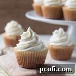 Close-up of a vanilla cupcake with buttercream frosting, simple yet perfect.