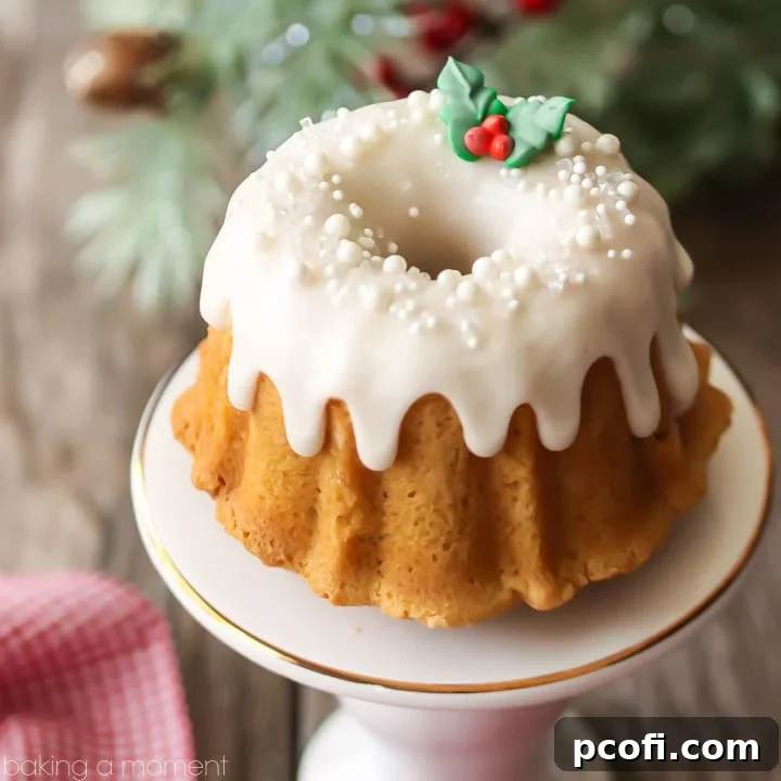 Mini brown sugar pound cake bundt with white icing and sprinkles, festive and giftable.