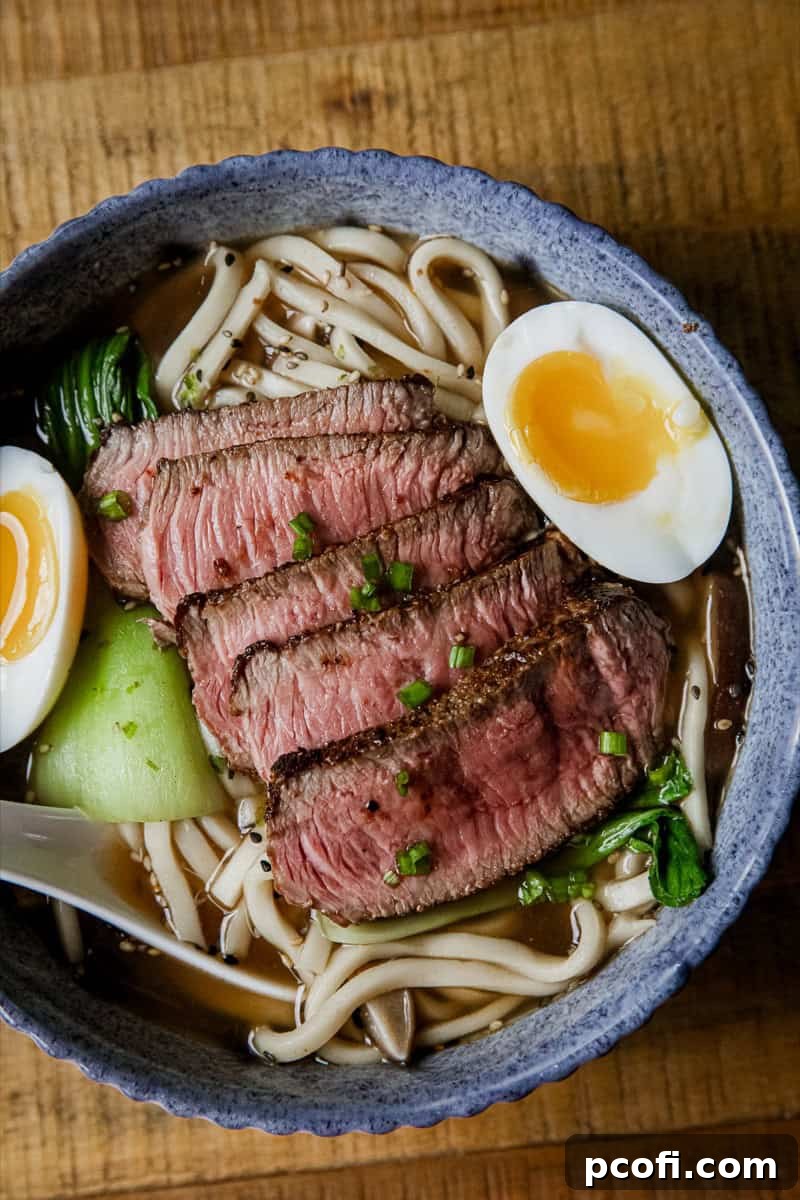 A bowl of hot Beef Udon Soup with noodles and sliced beef.