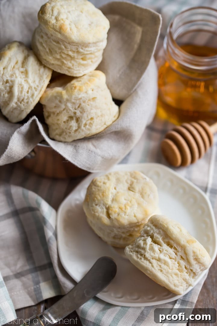 A stack of tall, incredibly fluffy buttermilk biscuits, baked to golden perfection, just like a Southern Grandma would make.
