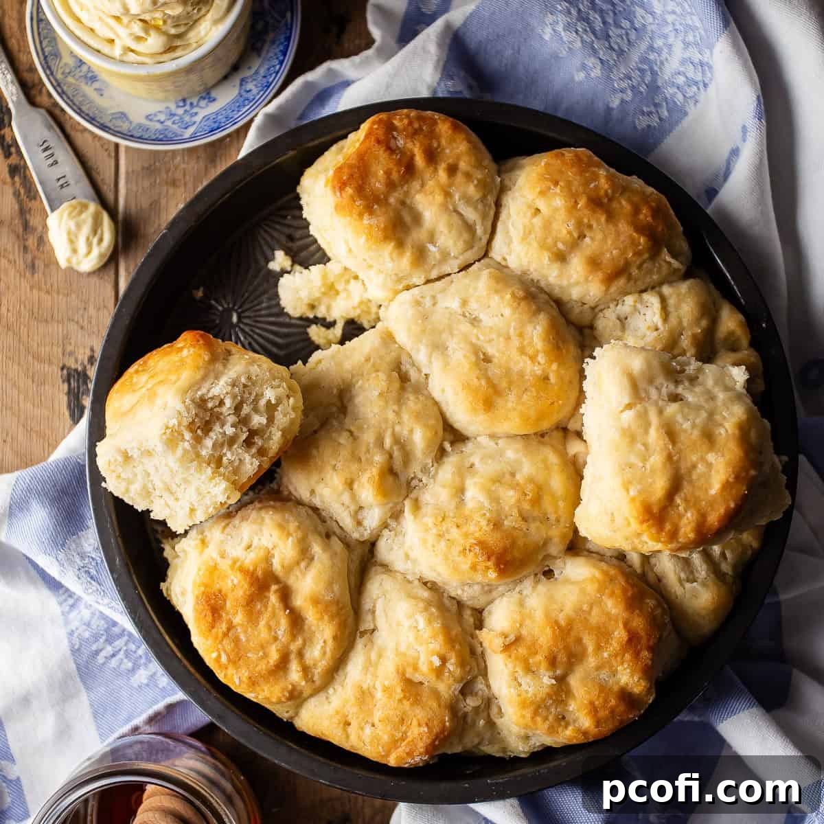 An overhead image of beautifully baked angel biscuits, arranged in a round pan, showing their incredibly fluffy texture.