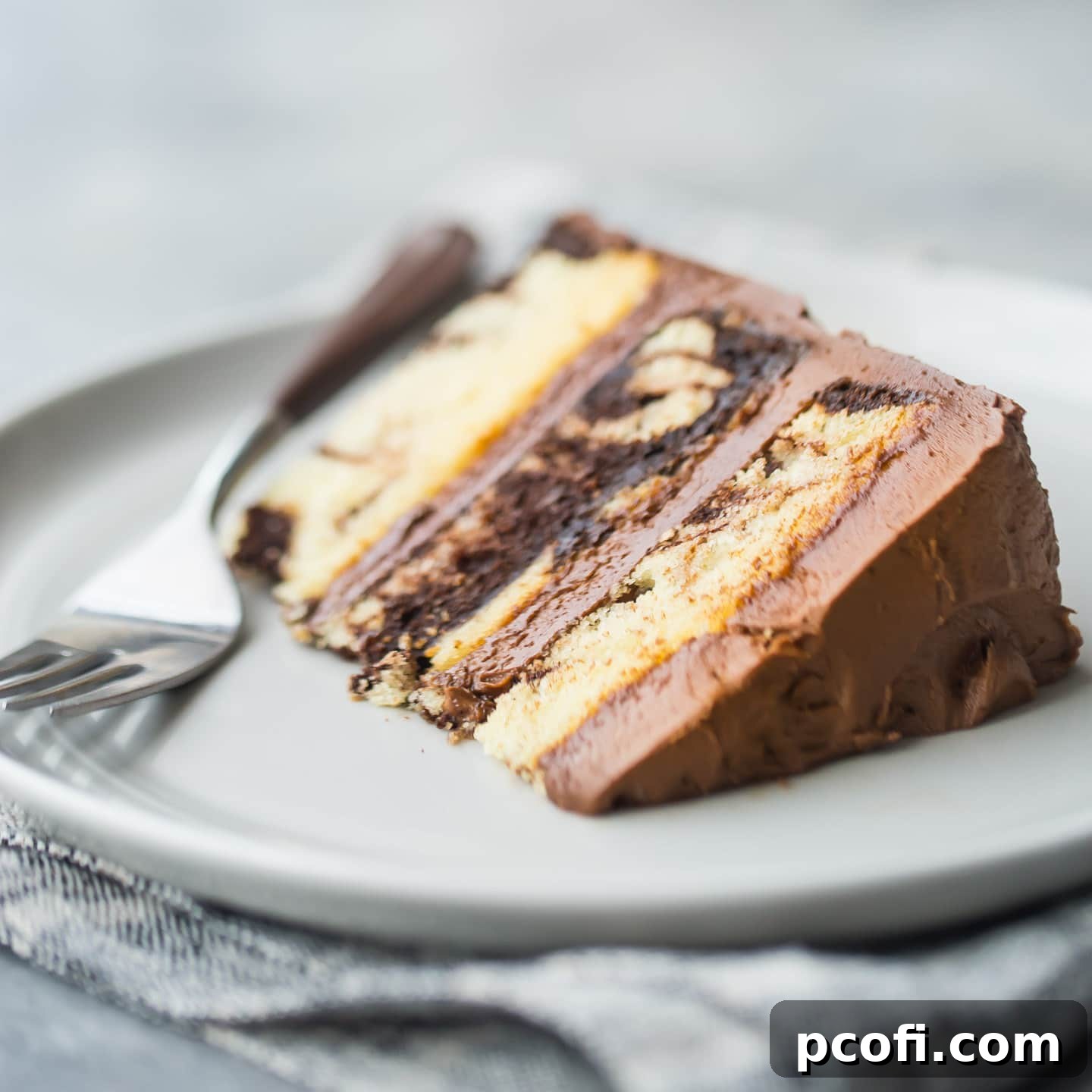 A beautifully swirled marble cake, showcasing distinct chocolate and vanilla patterns, promising a moist and rich dessert.