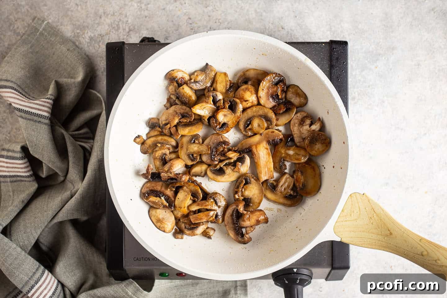 Sautéing sliced mushrooms in a skillet until golden brown and tender.
