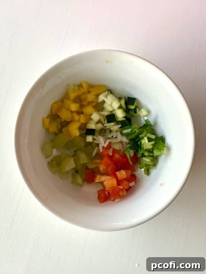 A small bowl of finely chopped fruit and vegetables, a bird's healthy meal.