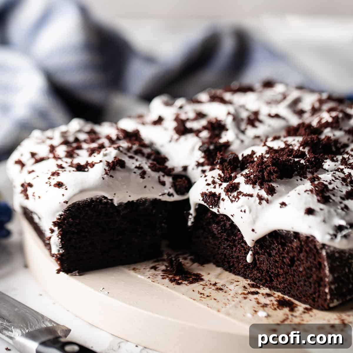 Devil's food cake baked in a square pan with marshmallow frosting.