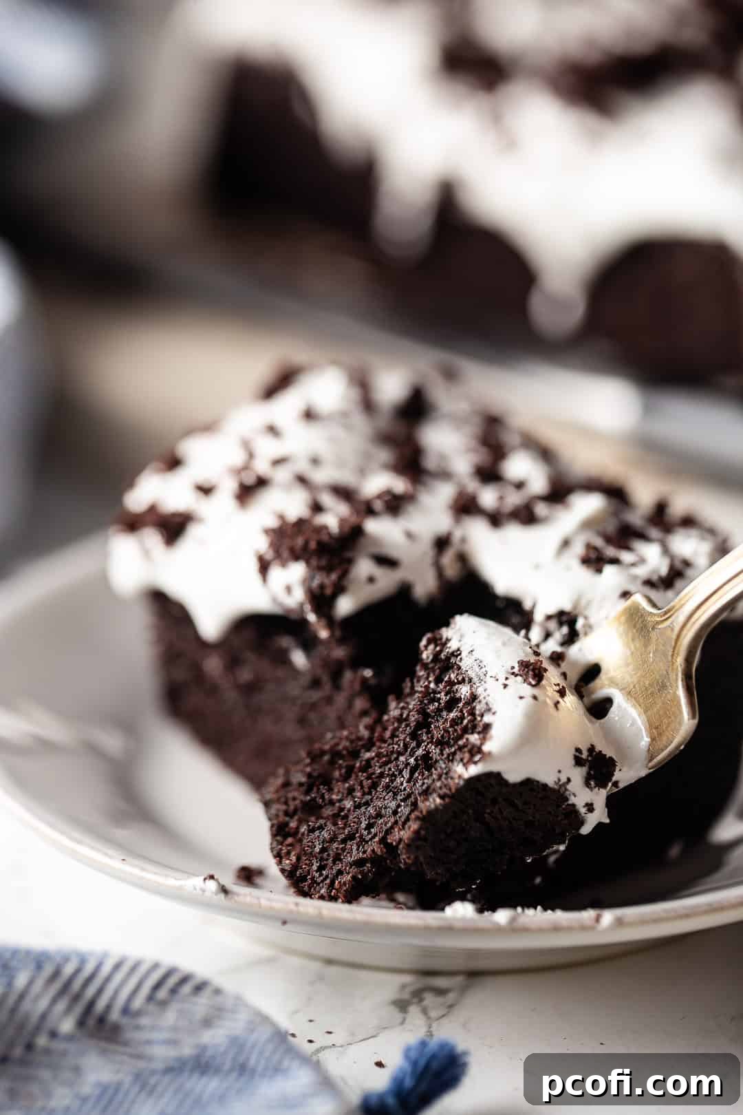 Devil's food chocolate cake served on a ceramic plate with a vintage silver fork.